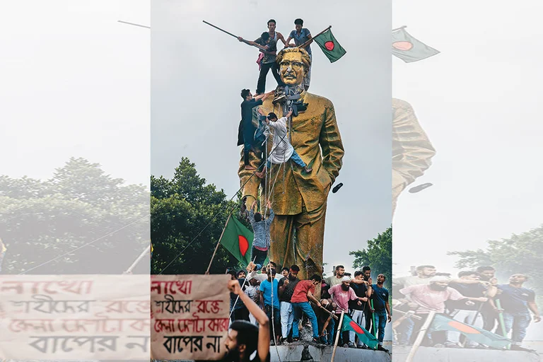 Bring it Down: Protestors climbing a statue of Sheikh Mujibur Rahman in Dhaka - Photo: Getty Images