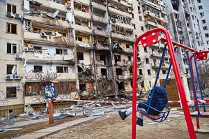 Photo: Getty Images : Civilian Targets: A child outside a residential building damaged by a missile strike in Kyiv, Ukraine 