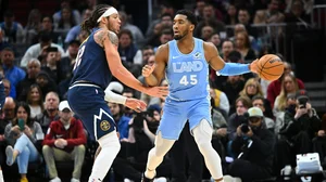 Aaron Gordon #32 of the Denver Nuggets guards Donovan Mitchell #45 of the Cleveland Cavaliers during the first quarter at Rocket Mortgage Fieldhouse on December 05, 2024 in Cleveland, Ohio.