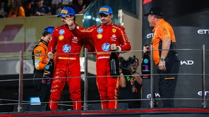 Leclerc (centre) and Sainz salute the crowd