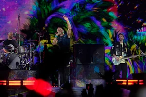 | Photo: AP : Coldplay performs at Mumbai's DY Patil Stadium