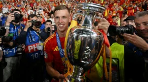 Dani Olmo poses with the Euro 2024 trophy.