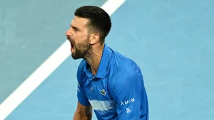 Novak Djokovic roars in celebration.