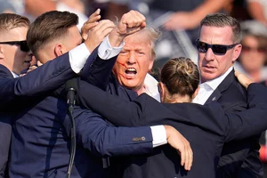 AP : Former US president Donald Trump survived an attempt on his life on Saturday when a young shooter fired multiple shots at him at a campaign rally in Pennsylvania, injuring his right ear. 

