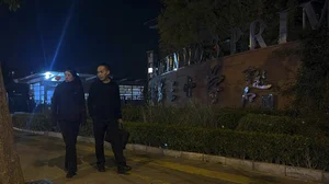 PTI : Plainclothes police officers pass by a primary school following a knife attack that occurred on an intersection road near a school in the northwestern Haidian district in Beijing, Monday, Oct. 28, 2024. 