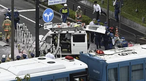 AP : Officials work near a vehicle, center, which was stuck against a barricade near the prime minister's office in Tokyo.