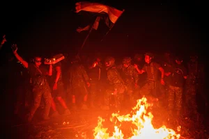 via Getty Images : Members of Karenni Resistance Force celebrate mission accomplishment in their base, in Shadaw Township.