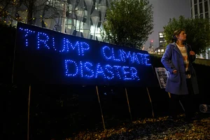 Getty Images : A banner reads 'Trump Climate Disaster' at a protest against Trump Presidency outside the US Embassy on Nov 6 in London