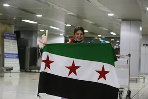 Getty Images : Relatives welcome Syrians returning from abroad at Damascus International Airport, where the first international flight landed on December 18