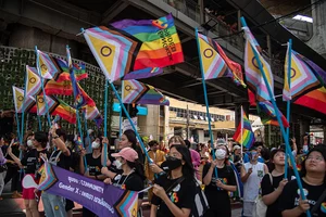 Peerapon Boonyakiat/SOPA Images/LightRocket via Getty Images : Participants march on Sukhumvit road while holding rainbow flags during the Bangkok Pride Parade 2023. 