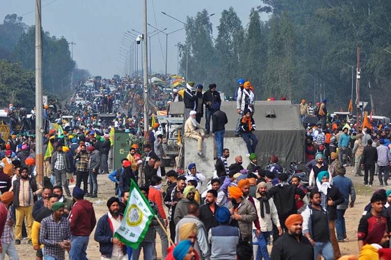 Farmers gather along a highway blocked by police as they try to march towards India's capital during a protest demanding minimum crop prices, at Shambhu Haryana-Punjab border near Ambala some 220 Km from New Delhi on February 13, 2024.  - Photo by SHAMMI MEHRA via Getty Images