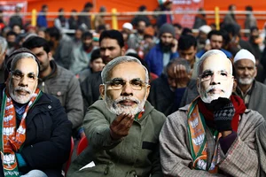 Getty Images : The Bharatiya Janata Party (BJP) supporters wear masks of Prime Minister Narendra Modi during his election rally in Srinagar in 2014.