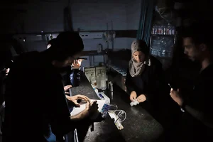 | Photo: Getty Images : Dire Times: Doctors at Kemal Adwan Hospital in Gaza are forced to work in the dark due to the electricity crisis in Gaza City