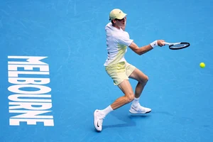 (AP Photo/Vincent Thian) : Jannik Sinner of Italy plays a forehand return to Holger Rune of Denmark during their fourth round match at the Australian Open tennis championship in Melbourne, Australia, Monday, Jan. 20, 2025. 