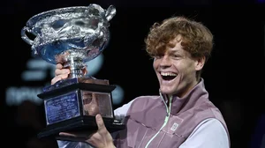 Jannik Sinner poses with the Australian Open trophy last year.