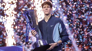 Jannik Sinner poses with the ATP Finals trophy.