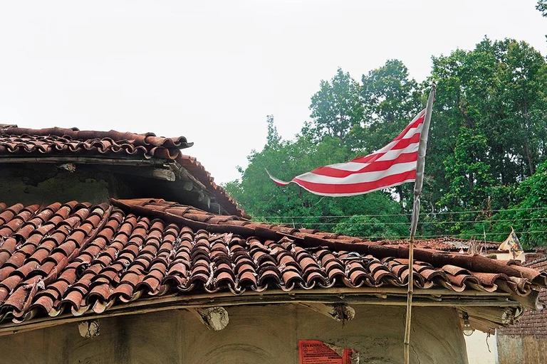 Religion and Politics: Sarna flag atop a house in  Arakeram village, Ormanjhi block, Ranchi - | Photo: Vikram Sharma