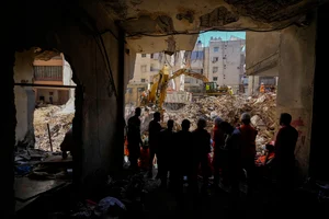 AP : Emergency workers use excavators to clear the rubble at the site of Friday's Israeli strike in Beirut's southern suburbs, Lebanon, Monday, Sept. 23, 2024. 