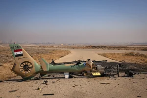 Photo: Getty Images : Shot Down: A Syrian Air Force helicopter is destroyed after Israeli 
strikes against military targets across Syria in December