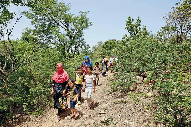 Rohingya women and children seeking shelter after a raid in the Jammu camps