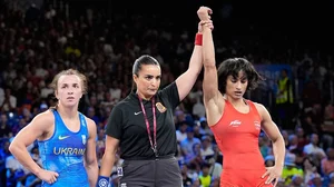 Photo: AP/Eugene Hoshiko : Paris Olympics Vinesh Phogat (right) in her bout.