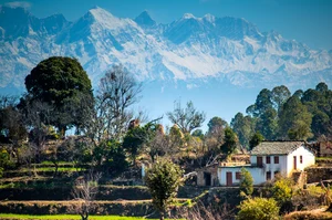 Shekhar Pillay/Shutterstock : Himalayan ranges form the backdrop to a serene village in Pithoragarh