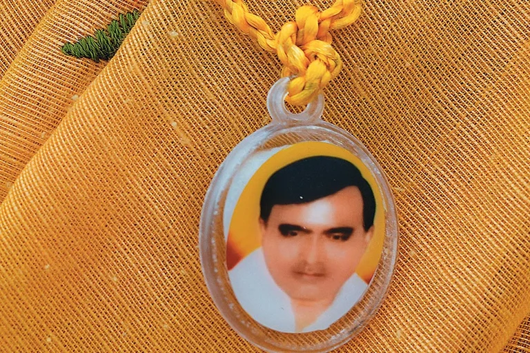 A devotee sports a pendant with Baba Bhole Nath’s face on it in Mainpuri, Uttar Pradesh, sold for Rs 10 each - Photo: Suresh K. Pandey