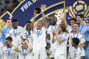 (AP Photo/Hussein Sayed) : Real Madrid's Kylian Mbappe, center, lifts the trophy after winning the Intercontinental Cup soccer final match against CF Pachuca at the Lusail Stadium in Lusail, Qatar, Wednesday, Dec. 18, 2024. Real Madrid won the game 3-0.