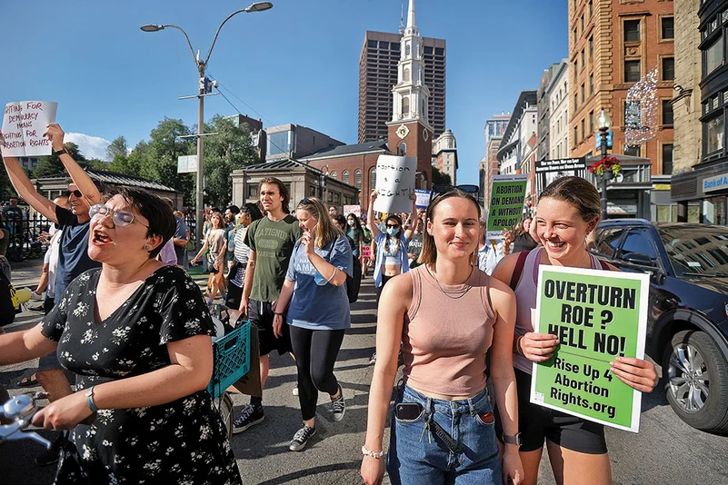 Hundreds of demonstrators march down Tremont street in Boston after the Supreme Court’s decision