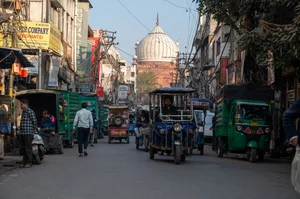 Shutterstock : A street view of Old Delhi with the bulbous dome of Jama Masjid in the far end