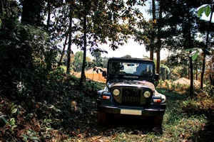 manoj_kulkarni/Shutterstock : A Mahindra Thar navigates the terrain of Kodagu in Karnataka