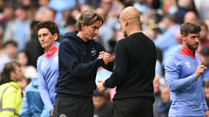 Thomas Frank shakes hands with Pep Guardiola.