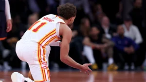 Trae Young #11 of the Atlanta Hawks celebrates the win on the logo after the quarterfinal game of the Emirates NBA Cup against the New York Knicks at Madison Square Garden on December 11, 2024 in New York City.