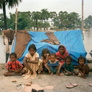 Getty Images : Belonging to the Musahar community (backward caste), these two women who had to flee their villages twice due to flooding, are forced to stay in makeshift plastic shelters set up on a road embankment in Bihar.
