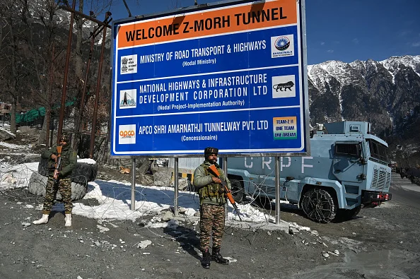 Paramilitary soldiers stand guard near Z-Morh Tunnel at Gagangeer some 82 kilometers from Srinagar